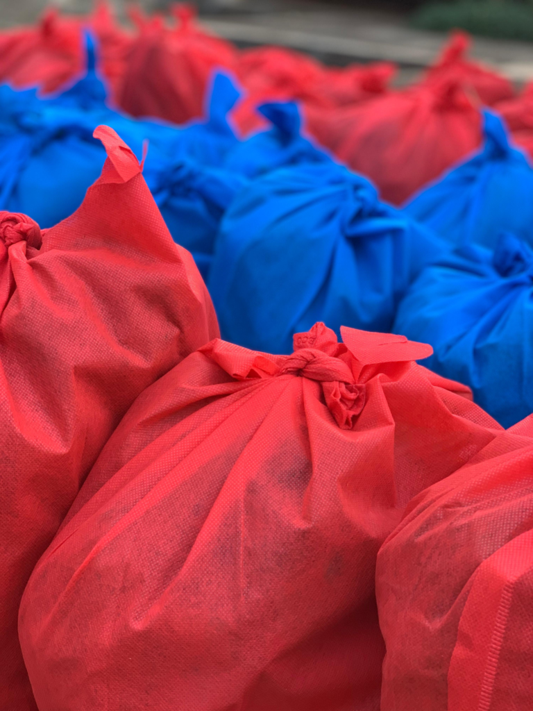 A close view of red and blue provision parcels donated for Kisasa FC players.